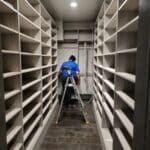 Roochii Cleaning employee providing home cleaning services by organizing and cleaning a closet.