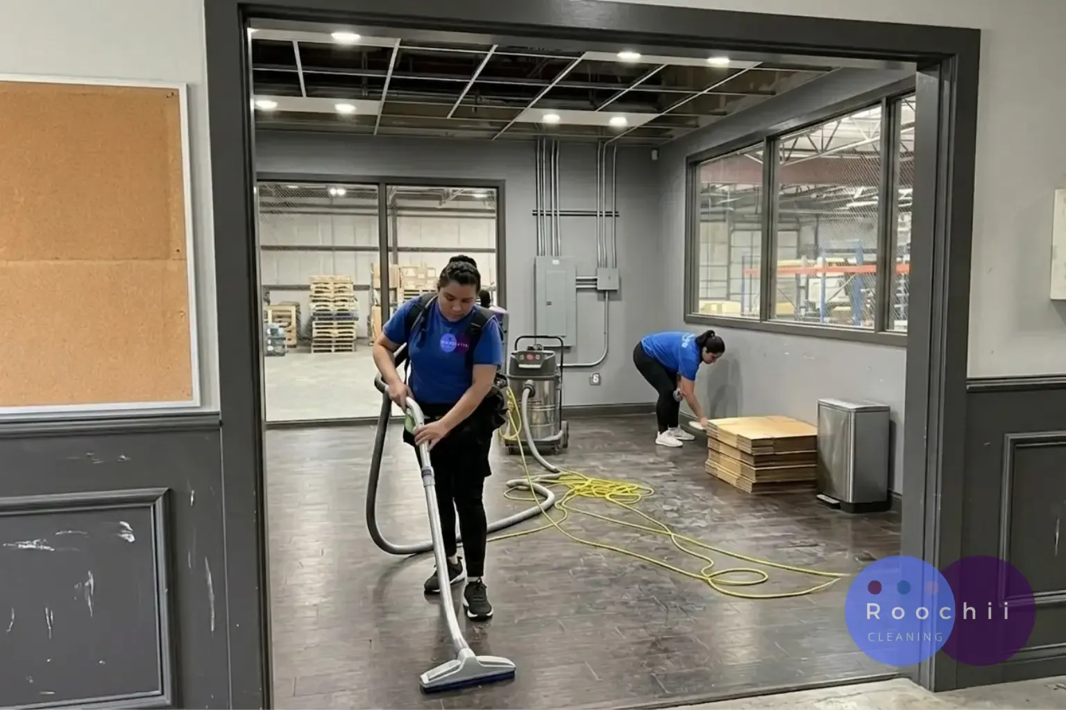 Professional cleaners providing the best commercial cleaning services in Denver by vacuuming floors and detailing a commercial office before business operations begin